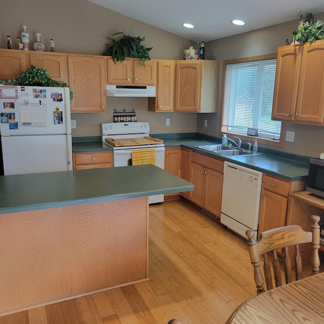 kitchen with white appliances, sink, vaulted ceiling, light hardwood / wood-style flooring, and light brown cabinetry