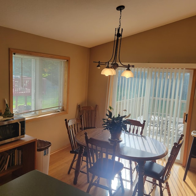 dining area with an inviting chandelier and light wood-type flooring