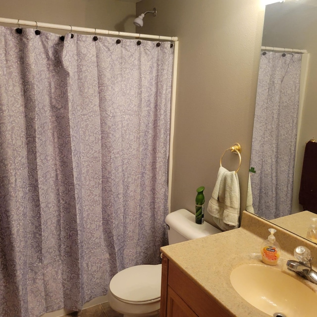 bathroom with tile patterned floors, vanity, and toilet