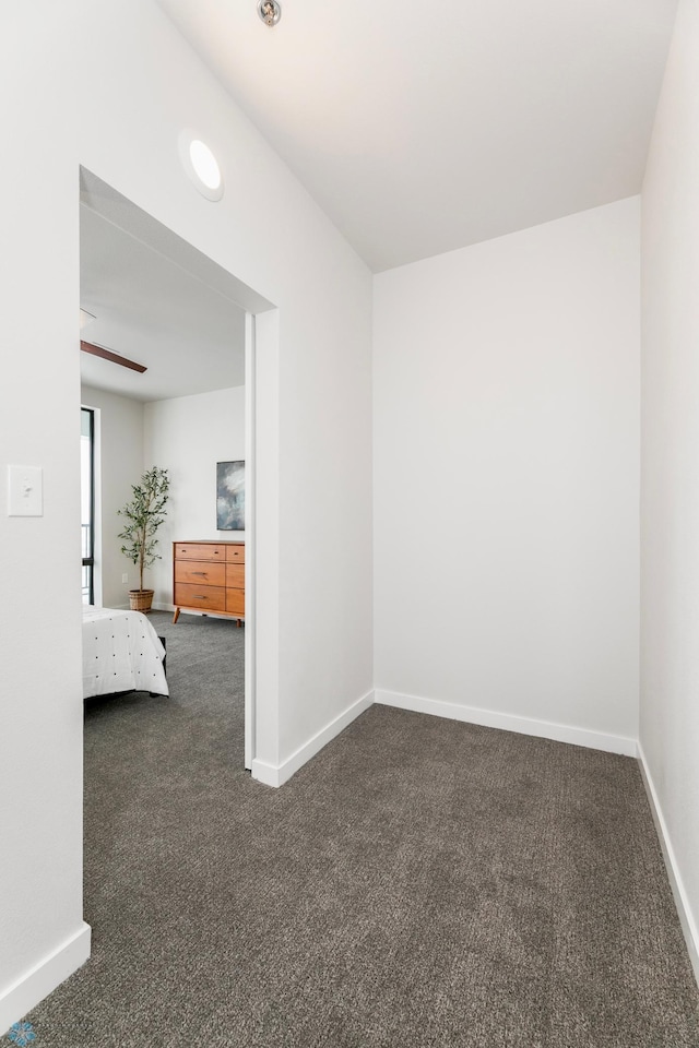 unfurnished bedroom featuring carpet flooring and baseboards
