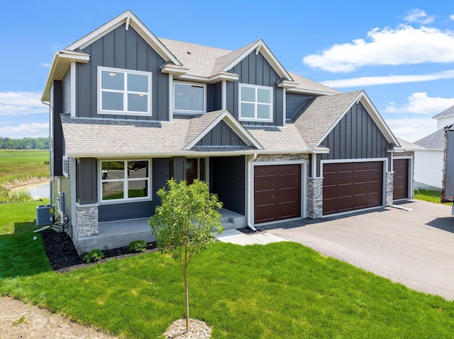 craftsman house with a garage and a front yard