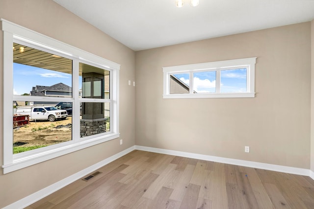 spare room featuring light wood-type flooring