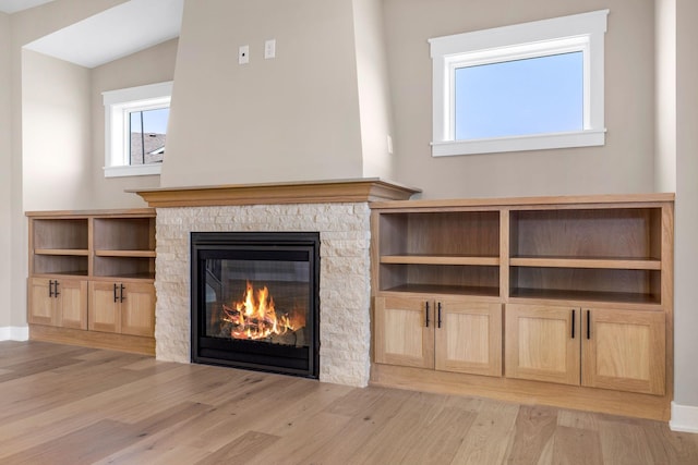 unfurnished living room with light hardwood / wood-style flooring and a fireplace