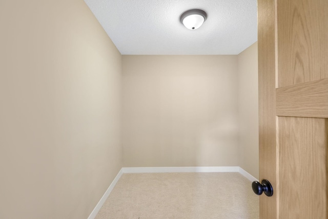 carpeted spare room with a textured ceiling