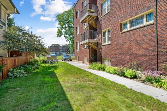 view of yard with a balcony