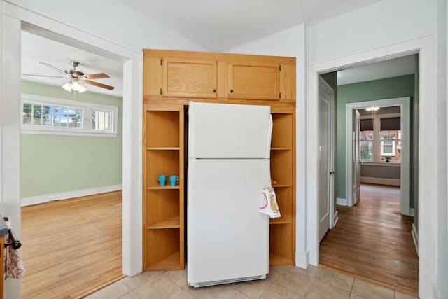 kitchen with light hardwood / wood-style flooring, light brown cabinetry, ceiling fan, and white fridge