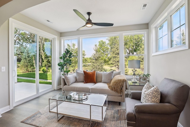 sunroom / solarium featuring ceiling fan