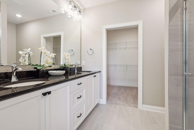 bathroom with dual bowl vanity and tile patterned flooring