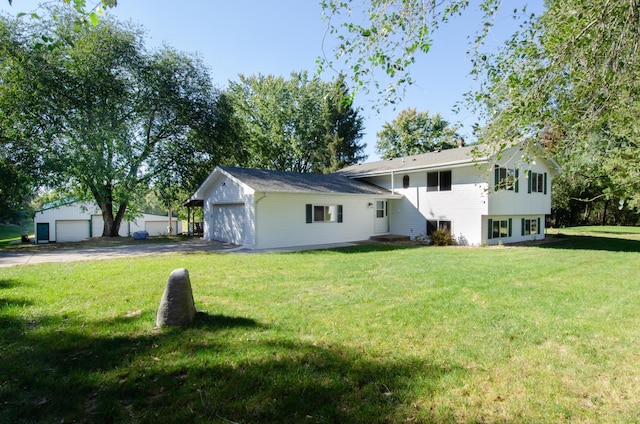 exterior space with a front yard, an outdoor structure, and a garage