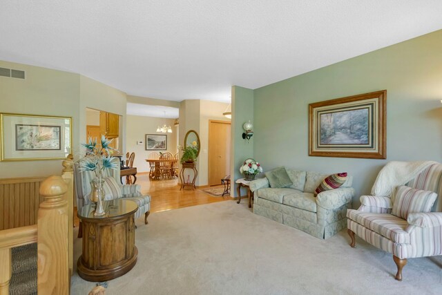 living room with visible vents and light colored carpet