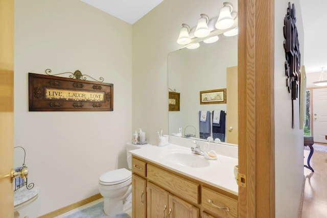 half bathroom with vanity and toilet