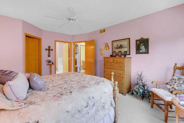 bedroom with a ceiling fan, light colored carpet, a closet, and visible vents