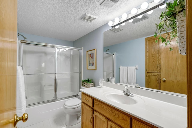 bathroom with visible vents, toilet, enclosed tub / shower combo, vanity, and a textured ceiling