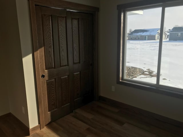 unfurnished bedroom featuring dark hardwood / wood-style floors and a closet