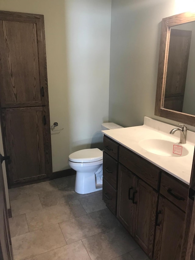 bathroom with toilet and vanity