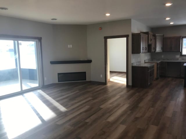 kitchen featuring dark wood-type flooring and dark brown cabinetry