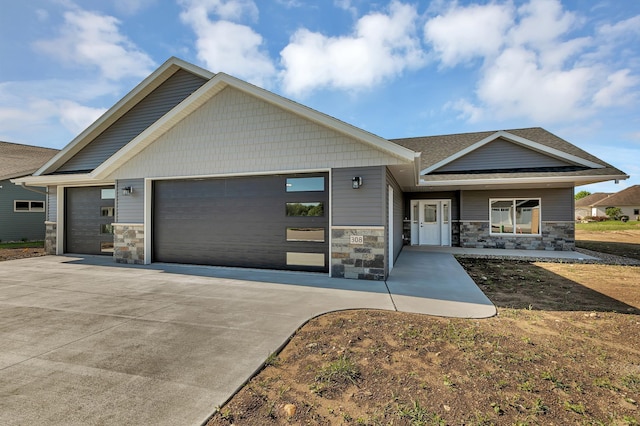308 15th St N, Cold Spring, MN 56320 - view of front facade featuring a garage, concrete driveway, and stone siding