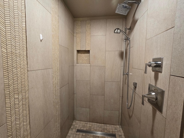 bathroom with tiled shower