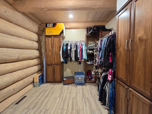 walk in closet with light hardwood / wood-style flooring