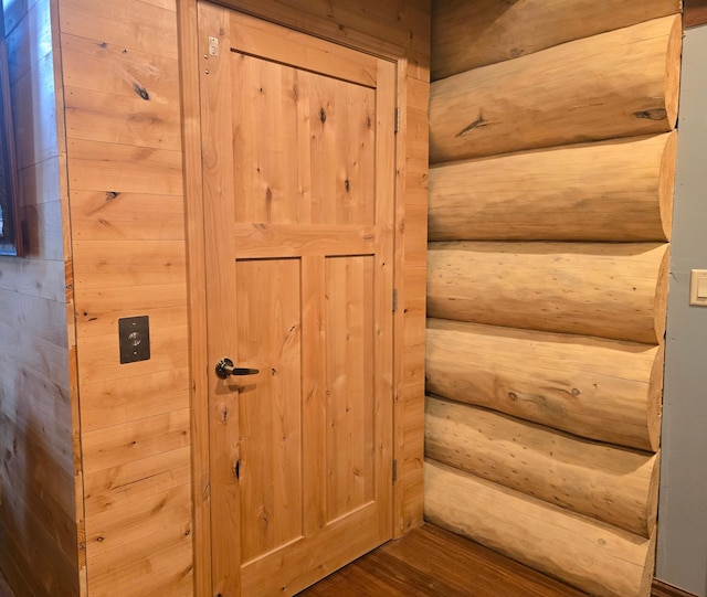 staircase featuring wood-type flooring and wood walls