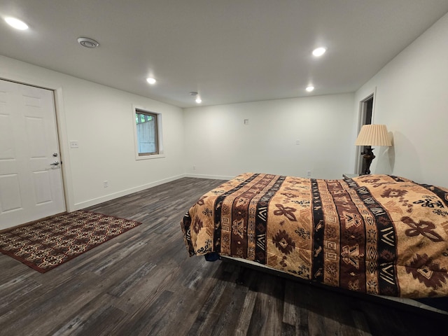 bedroom with dark hardwood / wood-style floors