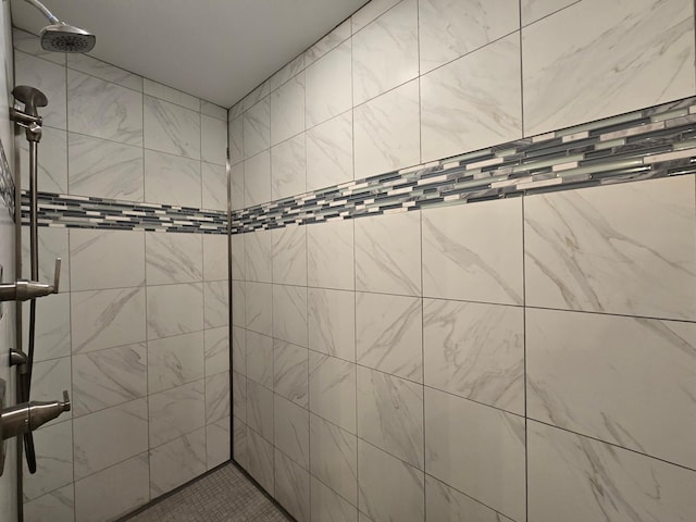 bathroom with a tile shower