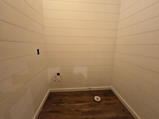 laundry area with wooden walls