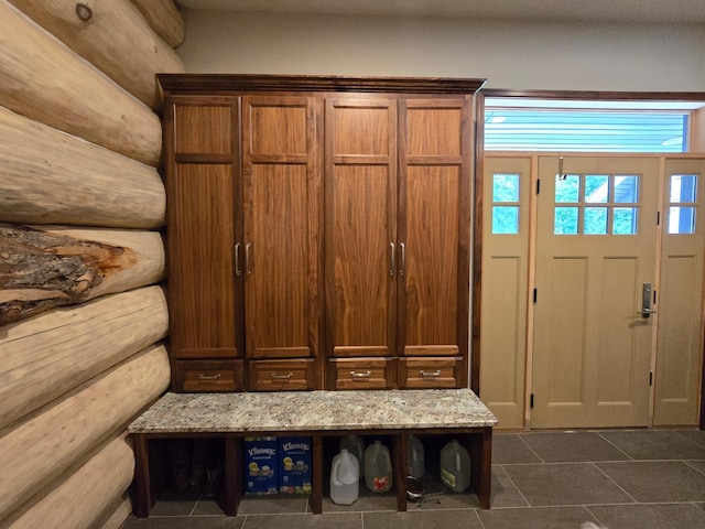 mudroom featuring dark tile patterned flooring