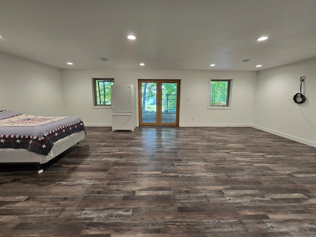 bedroom featuring white fridge, access to outside, and dark wood-type flooring