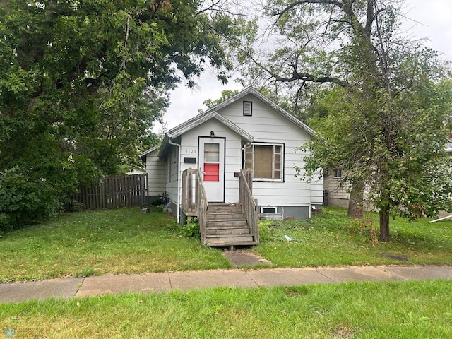 bungalow-style house with a front yard