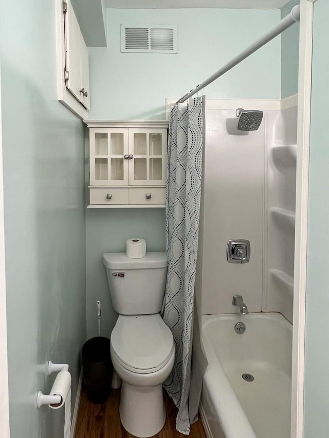 bathroom featuring toilet, shower / tub combo, and hardwood / wood-style floors