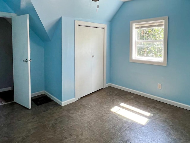 unfurnished bedroom featuring a closet and vaulted ceiling