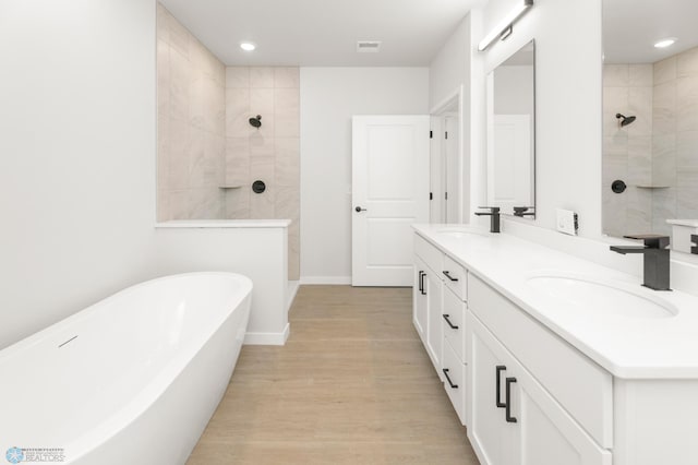 bathroom featuring vanity, hardwood / wood-style floors, and shower with separate bathtub