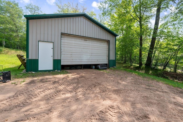 detached garage with dirt driveway