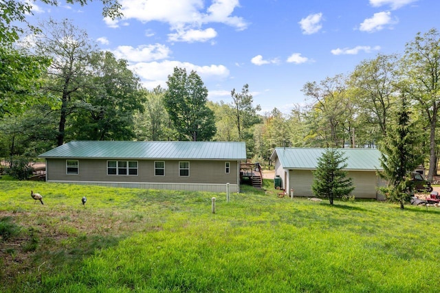 rear view of house featuring a yard