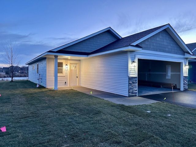 view of front of house with a garage and a yard