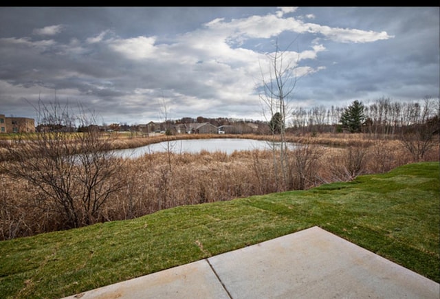 exterior space featuring a patio area and a water view