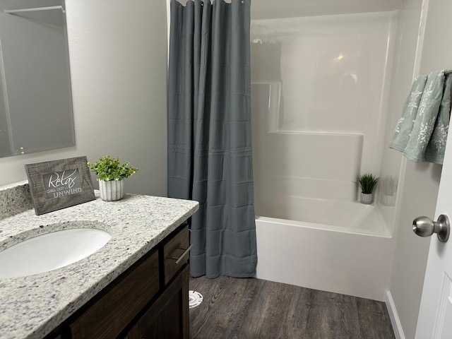 full bath featuring shower / bath combo, wood finished floors, and vanity