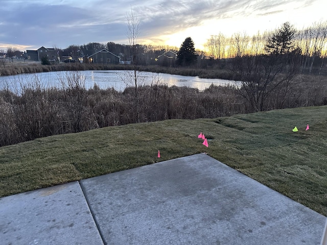 view of yard featuring a water view and a patio