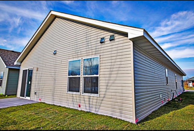 view of side of home featuring a lawn