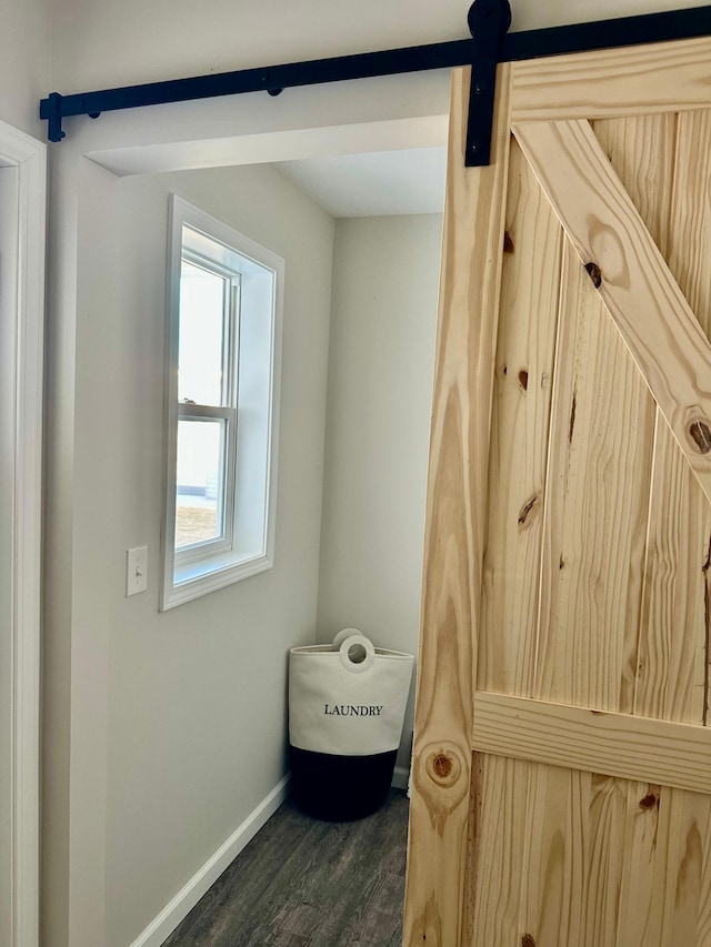 bathroom with wood finished floors and baseboards