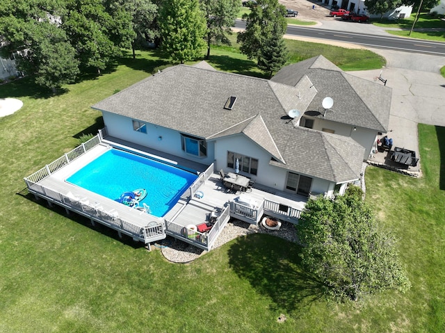 view of swimming pool featuring a deck, a yard, and area for grilling