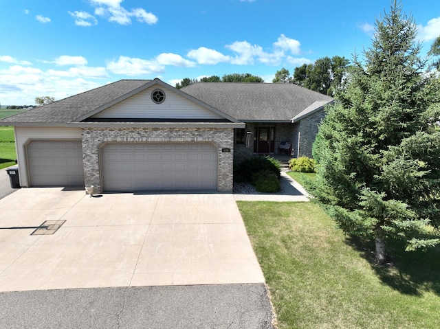 single story home featuring a garage and a front yard