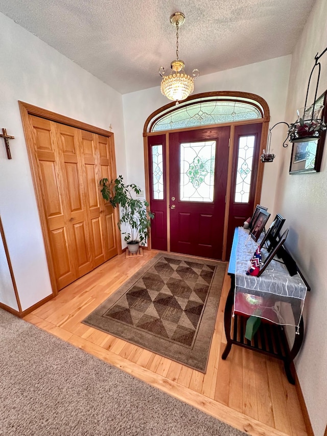 entrance foyer with hardwood / wood-style flooring and a textured ceiling