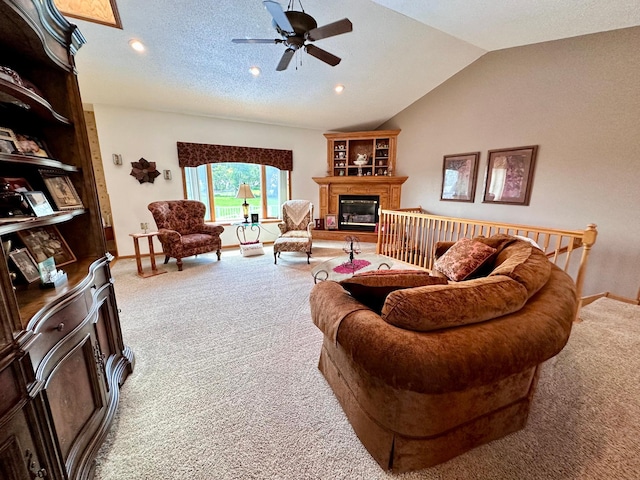 carpeted living room with a textured ceiling, ceiling fan, and vaulted ceiling