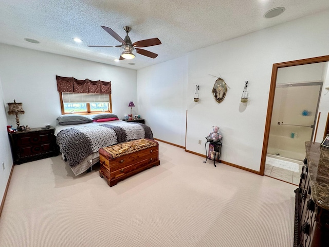 carpeted bedroom with ceiling fan, a textured ceiling, and connected bathroom