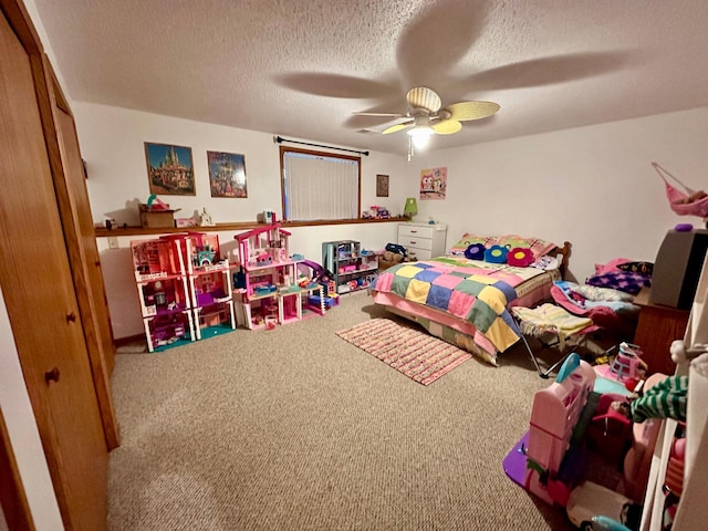 carpeted bedroom featuring a textured ceiling and ceiling fan