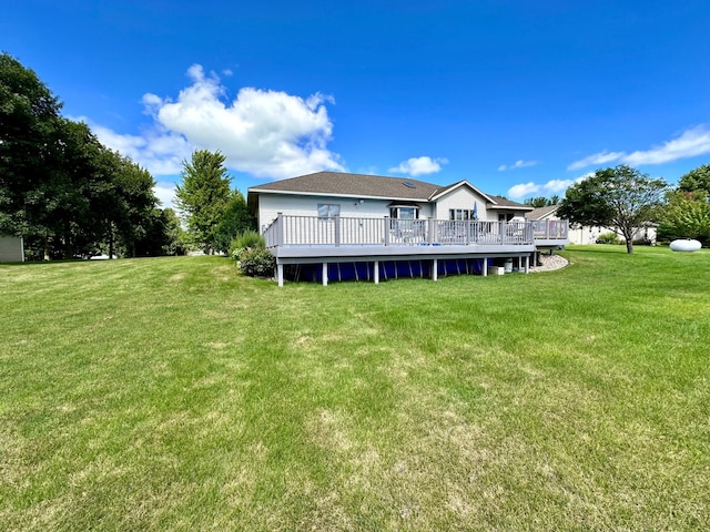 back of house featuring a deck and a yard