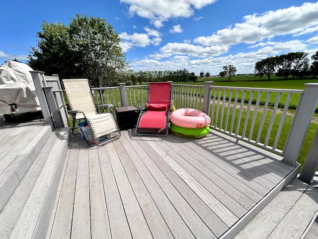 wooden terrace featuring a lawn