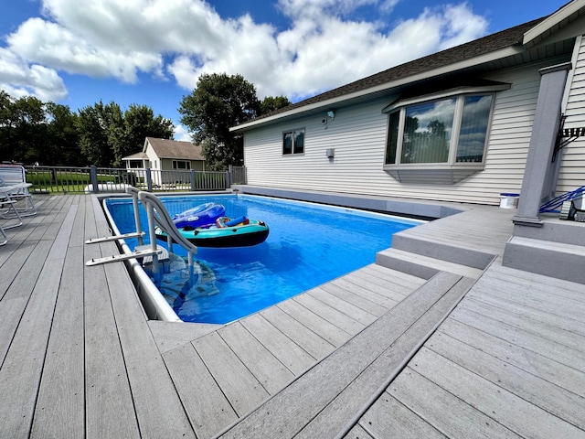 view of swimming pool with a wooden deck